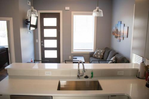 a kitchen with a sink and a living room at Music City Condo Near Downtown in Nashville