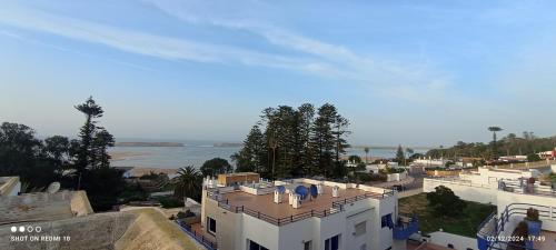 an aerial view of a white building and the ocean at Duplex 3 pour les familles in Oualidia