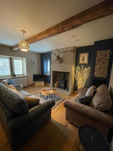 a living room with two couches and a fireplace at The Pickled Pheasant in Holmfirth