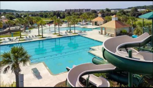 a large swimming pool with a slide at a resort at The Beautiful 31 in Port Wentworth