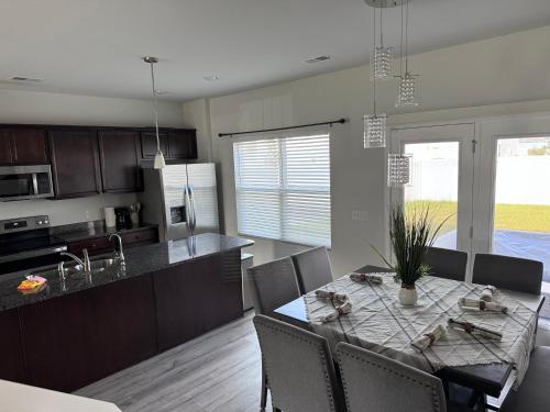 a kitchen and dining room with a table and chairs at The Beautiful 31 in Port Wentworth