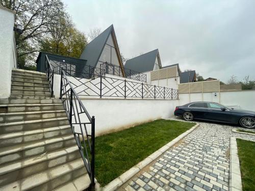 a car parked in front of a house with stairs at Aframe New in Uçgün