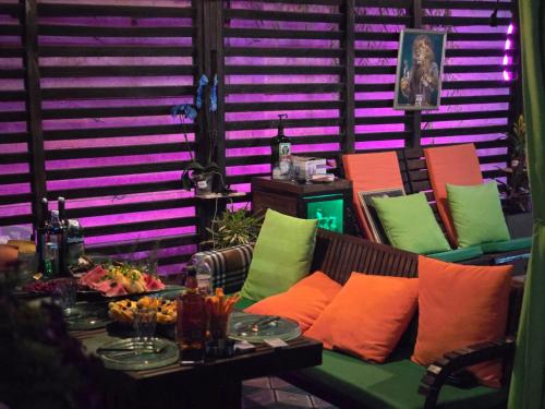 a room with a couch with colorful pillows and a table at Noragavit Villa in Yerevan