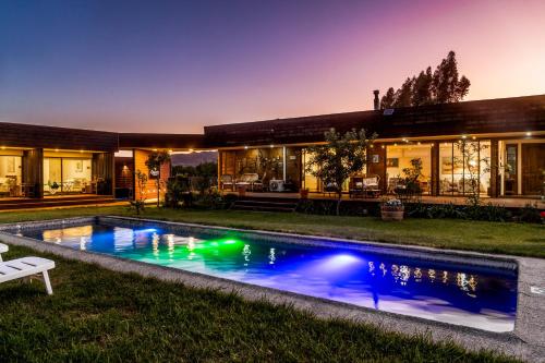 an exterior view of a house with a swimming pool at Casa Maqui in Santa Cruz