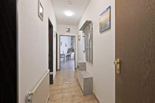 a hallway with a stairway leading to a room at Hotel Hülsmann Garni in Niedersachsen-Stadland