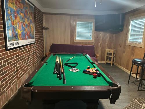 a room with a pool table in a room with a couch at Charming 3 Bedroom in Athens with WiFi and AC in Athens