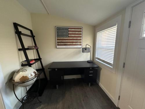 a desk in a room with a flag on the wall at Charming 3 Bedroom in Athens with WiFi and AC in Athens