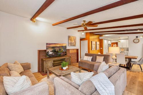 a living room with a couch and a table at Spacious Mid Century Modern Sunroom Rambler in Shoreline