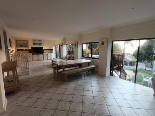 a living room with a bench and a table at Ascott Manor in Scottburgh
