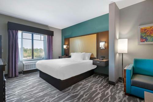 a hotel room with a bed and a couch at Best Western Plus Ruston Hotel in Ruston