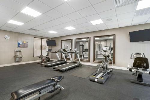 a gym with several treadmills and cardio machines at Best Western Plus Ruston Hotel in Ruston