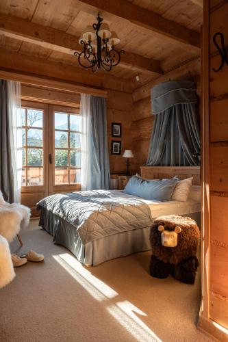 a bedroom with a bed with a teddy bear in it at Willa Rajka in Zakopane