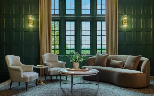 a living room with a couch and two chairs and a table at Pendry Natirar in Peapack