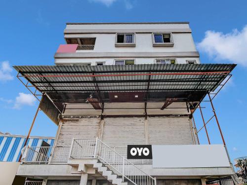 a tall building with a sign in front of it at Hotel O King's Inn in Dhantoli