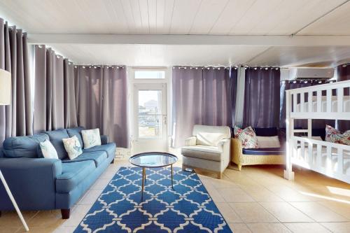 a living room with a couch and a crib at Southern Sunsets in Destin
