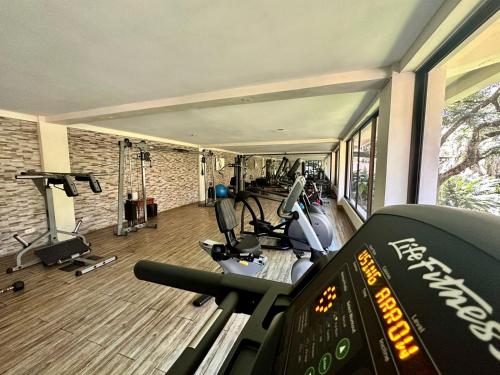 a gym with several treadmills and cardio equipment at Parador Nature Resort and Spa in Manuel Antonio