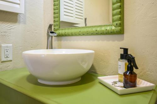 a white bowl sink on a green counter in a bathroom at The Islander- Luxurious Beach Property in Hilton Head Island