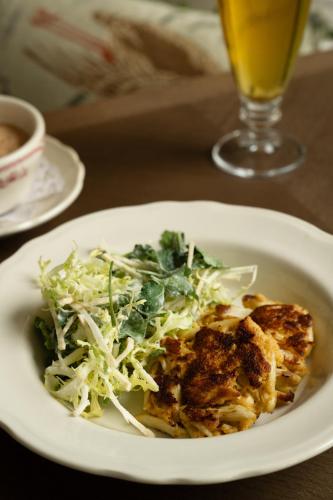 a white plate of food with a salad and a drink at Pendry Natirar in Peapack