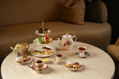 a table with cups and saucers of tea and biscuits at Pendry Natirar in Peapack