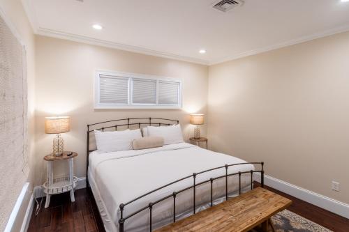 a bedroom with a bed and two lamps and a table at The Newport Lofts - 546 Thames Street in Newport