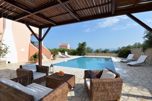 a patio with chairs and a swimming pool at Blue Horizon in Gaios