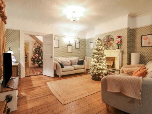 a living room with a christmas tree in a room at Rough Hill House in Chelmsford
