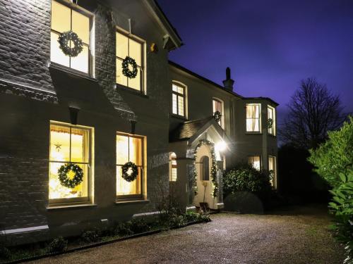a house with wreaths on the windows at night at Rough Hill House in Chelmsford
