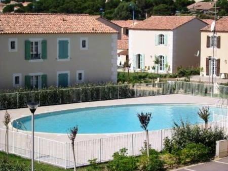 une grande piscine devant une maison dans l'établissement NP100-2203 Appartement 3 pièces, Narbonne Plage, à Narbonne-Plage