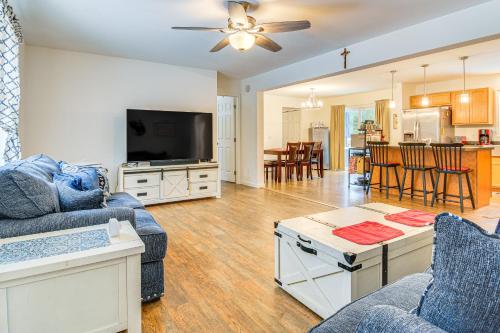 a living room with a couch and a tv at Near Skiing Serene Harrison Retreat with Fire Pit in Bridgton