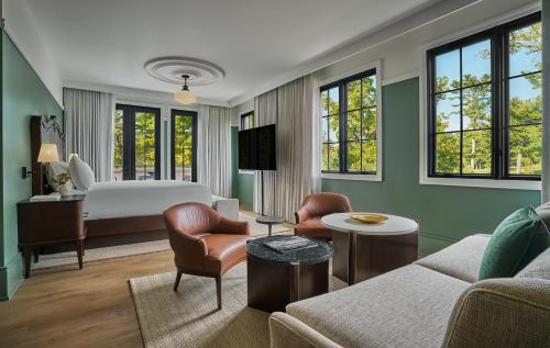 a bedroom with a bed and a living room at Pendry Natirar in Peapack