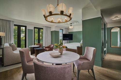 a living room with a table and chairs and a bedroom at Pendry Natirar in Peapack