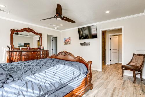 a bedroom with a bed and a mirror and a chair at Fenced Yard Modern Barndominium in Amarillo! in Soncy