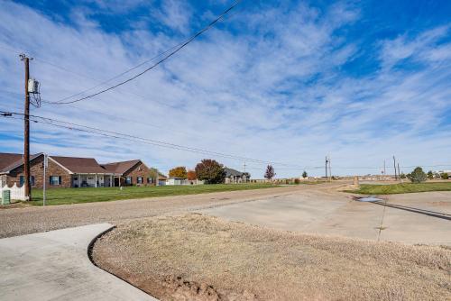 an empty road in a residential neighborhood with houses at Fenced Yard Modern Barndominium in Amarillo! in Soncy