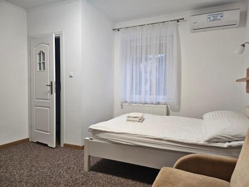 a small bedroom with a bed and a window at "Hel" Wieniec Zdrój in Włocławek