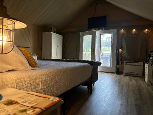 a bedroom with a bed and a large window at Piney River Resort in Bon Aqua