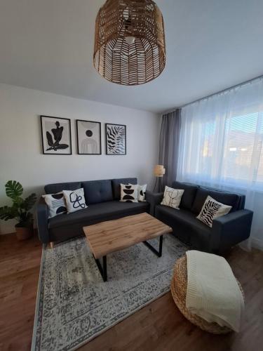 a living room with a blue couch and a coffee table at Apartmán OLI Banská Bystrica in Banská Bystrica