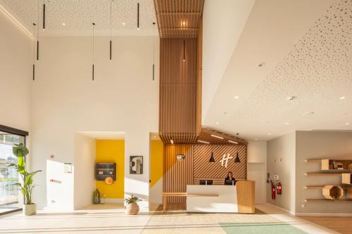 a living room with yellow walls and a ceiling at Holiday Inn Braga by IHG in Braga