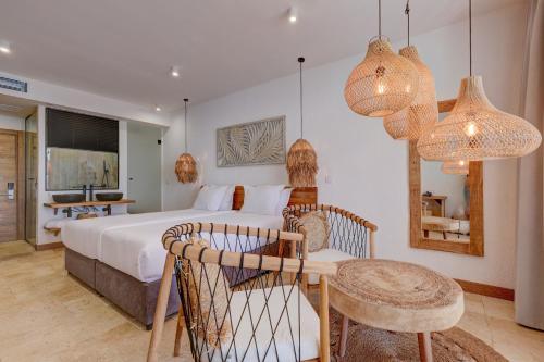 a bedroom with a bed and a table and chairs at La Boheme - Adults Only in Obzor