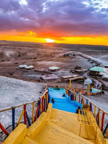 a view of a water park at sunset at La Dune Agafay Desert Camp in Marrakech