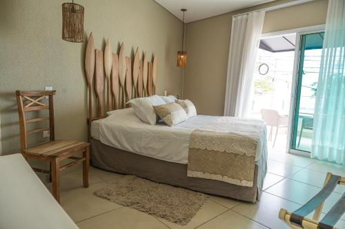 a bedroom with a bed with skis on the wall at Hotel VillaReal Charme in Guaratuba