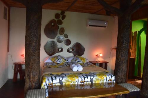 a bedroom with a bed with rocks on the wall at Villa Girasol in Sarapiquí
