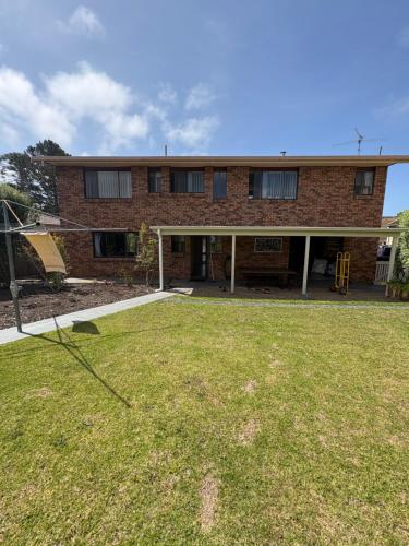 a brick house with a yard in front of it at Beach N Berms in Dalmeny