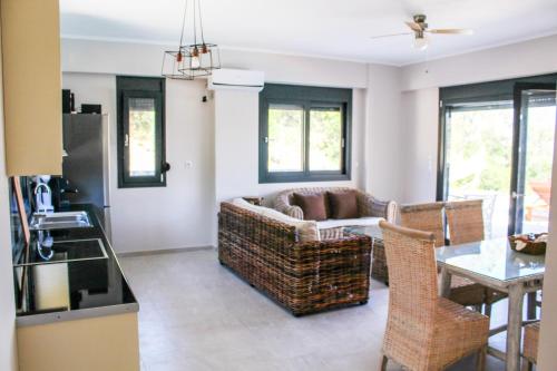 a living room with a couch and a table at Villa Maura-Lefkada - Jimdo in Nydri