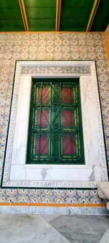 a stained glass window on a wall at Dar Ben Jemia- Sidi Bou Saïd in Sidi Bou Saïd