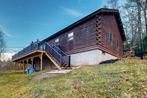 a house with a staircase on the side of it at Loon Lodge on Locke Lake in Center Barnstead