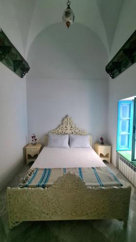 a bedroom with a large bed in a room at Dar Ben Jemia- Sidi Bou Saïd in Sidi Bou Saïd