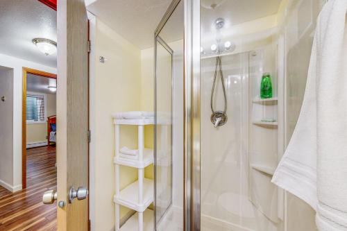 a bathroom with a shower with a glass door at Red Deck Retreat in Anchorage