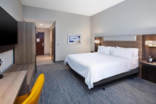 a hotel room with a large bed and a tv at Holiday Inn Express & Suites I-26 & Us 29 At Westgate Mall by IHG in Spartanburg