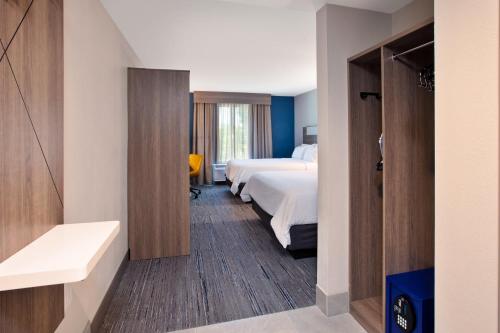 a hotel room with two beds and a bathroom at Holiday Inn Express & Suites I-26 & Us 29 At Westgate Mall by IHG in Spartanburg