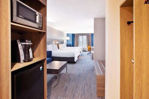 a hotel room with a bed and a tv at Holiday Inn Express & Suites I-26 & Us 29 At Westgate Mall by IHG in Spartanburg